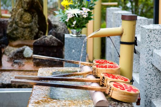 Ladles for hands cleaning at entrance of temple in Nikko, Japan