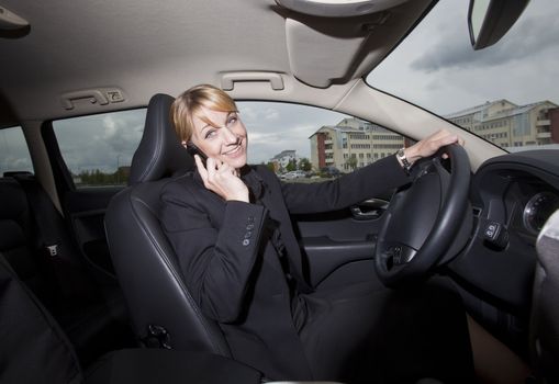 Woman on the phone when she driving in her car