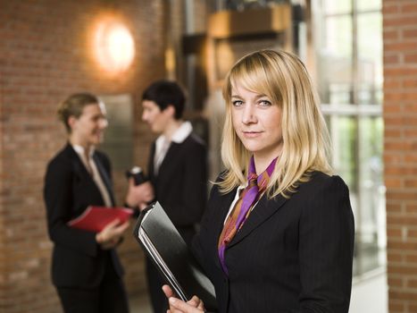 Businesswoman in front of two women