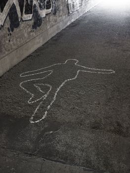 Contour of a person drawn at the asphalt