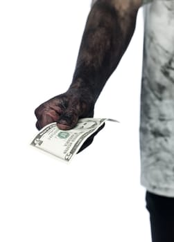 Dirty hand holding a five dollar bank note