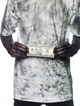 Very dirty person holding a five dollar bank note