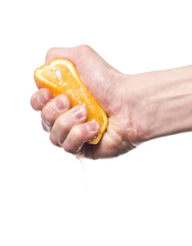 Hand squeezing an orange towards white background