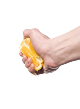 Hand squeezing an orange towards white background