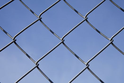 Fence as a pattern towards blue sky