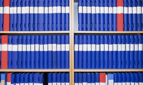 Several binders in a bookcase