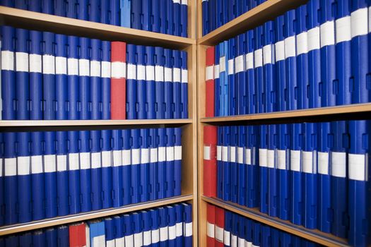 Several binders in a bookcase