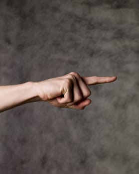 Pointing finger towards grey background