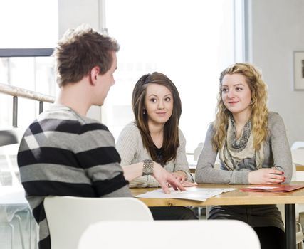 two girls and a man talking