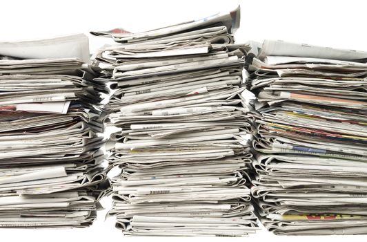 Three piles of newspapers