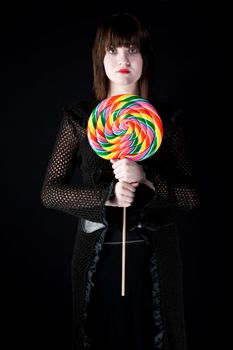 Pretty emo girl with bright colorful lollipop