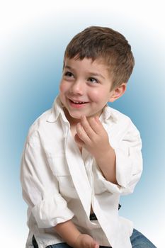 Beautiful young boy with a gorgeous smile - blue background