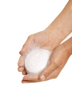 Hands holding lathered soap on a white background, 