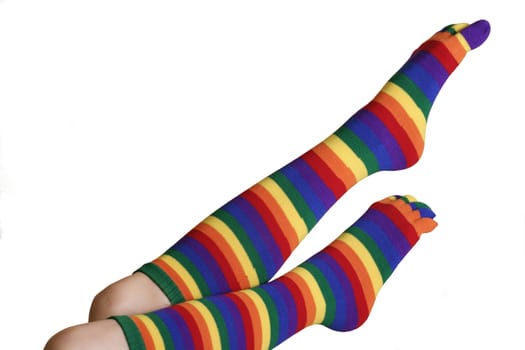 Legs showing knitted wool socks in stripey colours.