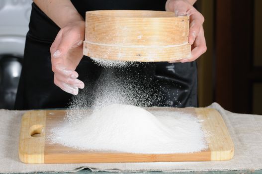 Flour sifting through a sieve for a baking