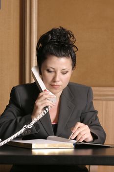 Business professional on phone with schedule/diary