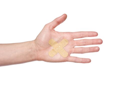 Hand with bandaid isolated on a w hite background