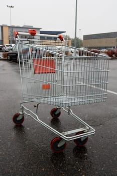 Empty shopping cart in a store parking lot