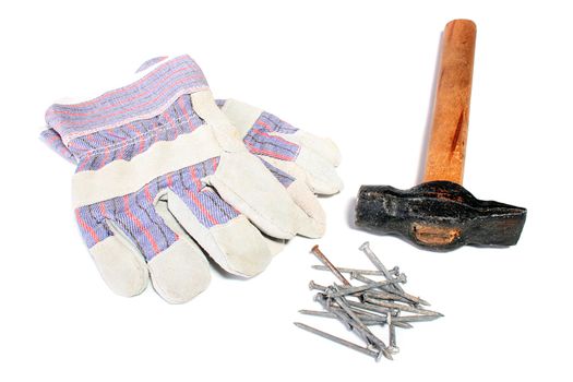 Hammer with the wooden handle, nails and gloves for protection of hands during civil work.