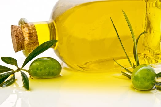 olive oil and olives on white background