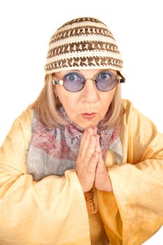 Crazy new age woman with hands together in a yellow robe