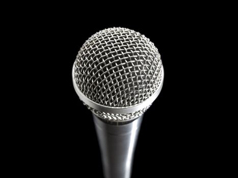 A dynamic microphone over a black background.