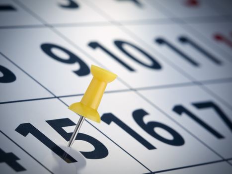 A yellow push pin on the 15th day of a calendar.