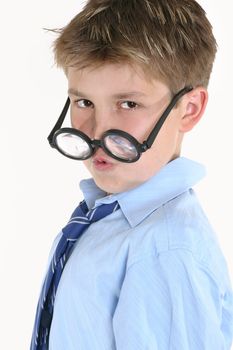 Child looking over the top of round glasses.