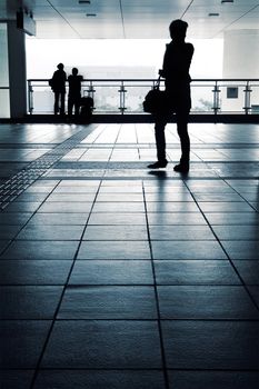 One woman and couple silhouette in the station.