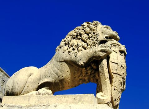 Medieval stone sculpture of lion guarding the gates of the old city of Mdina in Malta