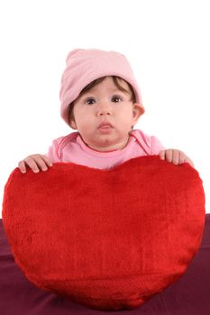 Cute little baby holding a big red heart