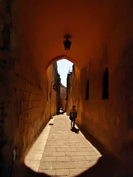 Shadow and light through old medieval archway in Mdina, Malta