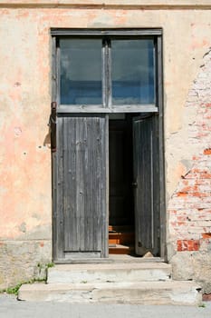 Old door in an abandoned brick building