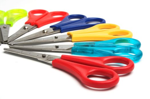 Some colored scissors over white