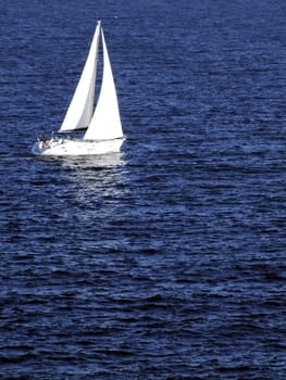 Yacht or sailing boat on calm ocean waters off the Mediterranean coast