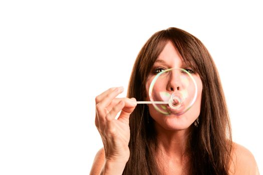 Pretty hippie woman with long hair blowing bubble