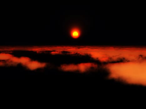 View of the setting sub high over the clouds.