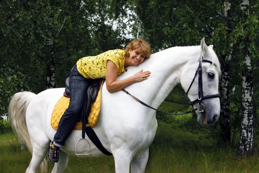 photo of the joyful lady on horse in forest