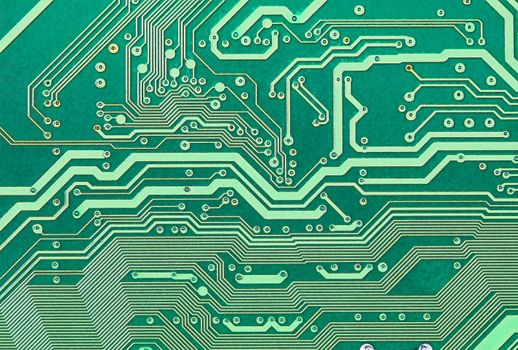 Texture of an electronic plate of green color with metallic paths