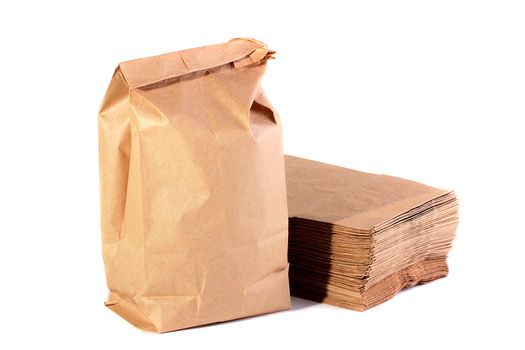 Paper packages for the dinners, one of packages with meal, the others a pile are combined on a background.