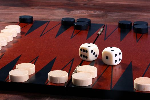 Set for game in a backgammon, a counter white and black, two cubes, a game field.