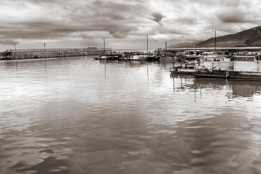 Fishing boats on the sea in the port before storm coming.