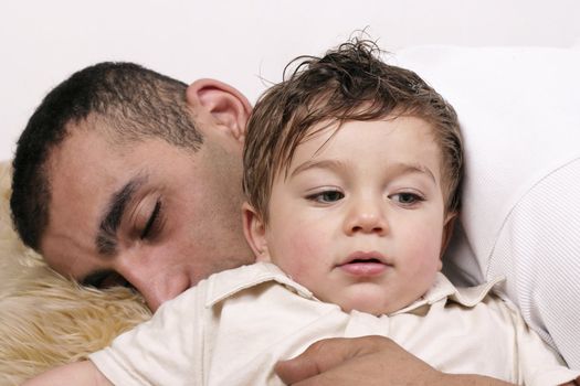 Father and son relaxing on a rug