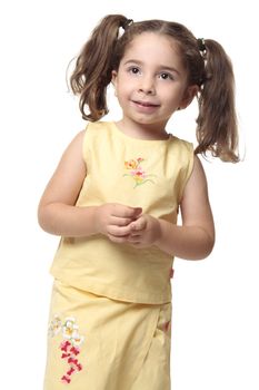 Smiling little girl with hair pulled into ponytails