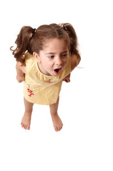 A young little girl with fists clenched screams or throws a tantrum