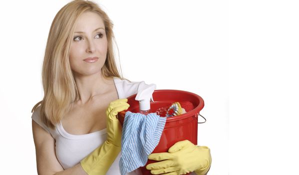 A woman with bucket and cleaning products ready for some house chores.