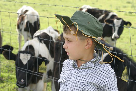 Little farmer boy with his cattle