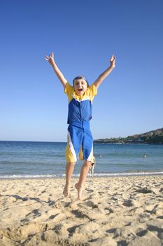 Woo Yah! Child leaps into the air on the beach -- very late autumn afternoon. 