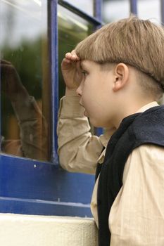 A child looking into an old storefronts window