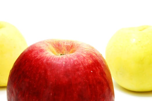 Red Apple in front Row of Yellow Apples Isolated on White